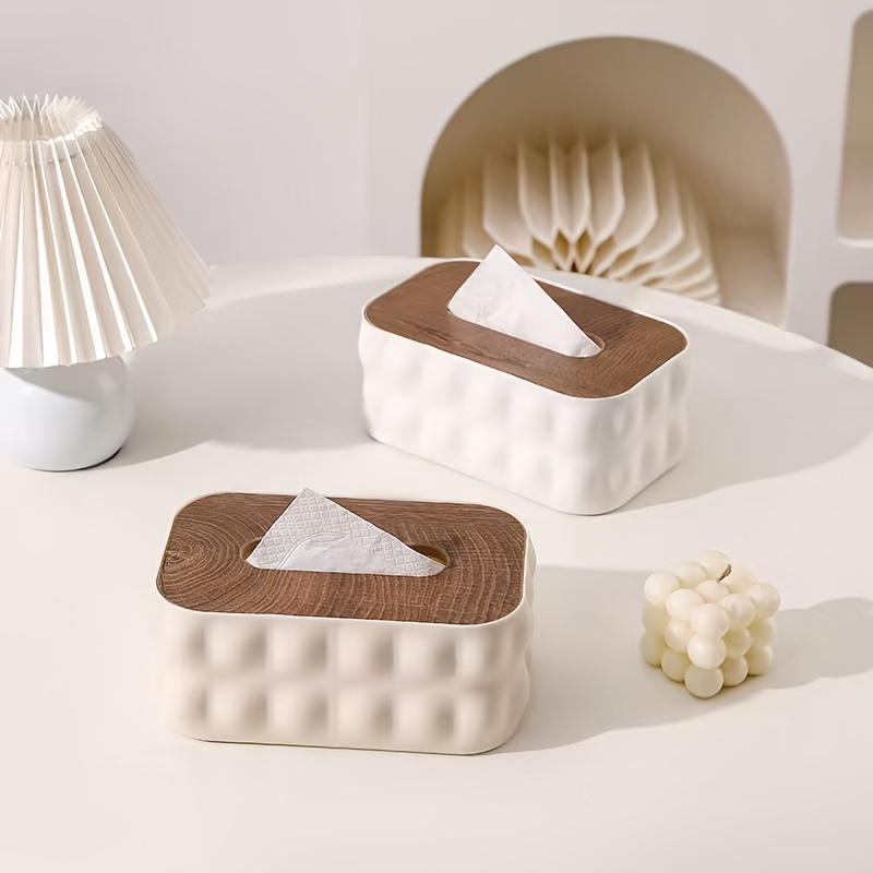 Modern white acrylic tissue box with spring-loaded lid and wood-grain finish.