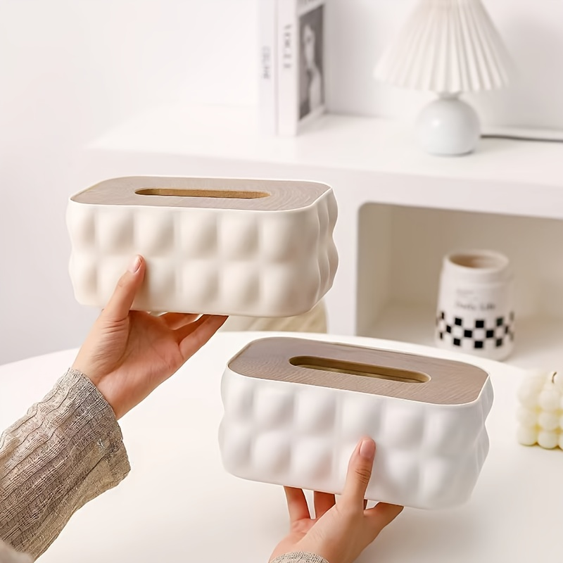 Modern white acrylic tissue box with spring-loaded lid and wood-grain finish.